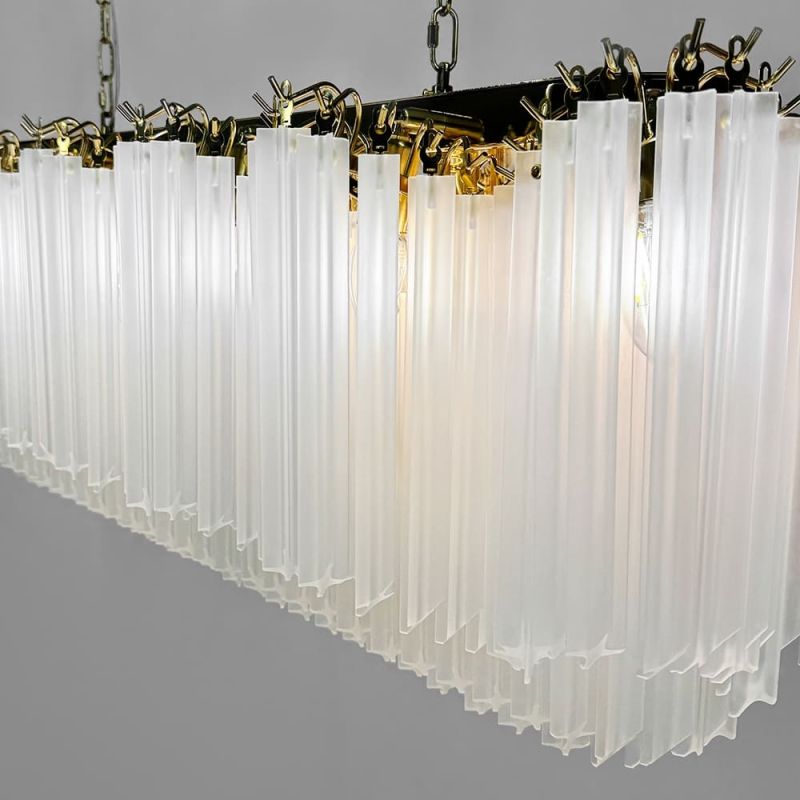 Латунна люстра з матовими скляними підвісками у видовженому корпусі 110х30 см